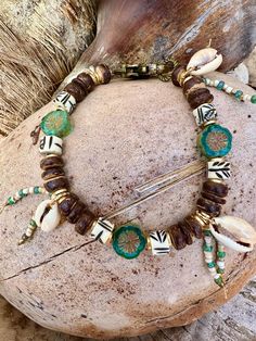 Hawaii Cowrie Shell bracelet, made up on Cowrie Shells, coconut beads, African bone painted beads, Czech Glass flowers, attached with brass clasp Cowrie Shell Bracelet, Painted Beads, Cowrie Shells, Shell Bracelet, Cowrie Shell, Glass Flowers, Czech Glass, Arm Band, Bones