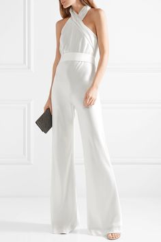 Influenced by old Hollywood glamour, Galvan's white jumpsuit is a sophisticated option for modern brides. Made from languid satin, it has an asymmetric halterneck that elegantly twists in the front and turns to reveal a cascading sash. It's expertly bias-cut to fit close through the waist before falling to a flared hem.  Shown here with: [Jimmy Choo Clutch id983297], [Gianvito Rossi Sandals id1043548], [Bottega Veneta Earrings id991836]. Nontraditional Bride, Halterneck Jumpsuit, June Bug, Crepe Jumpsuit, Moda Chic