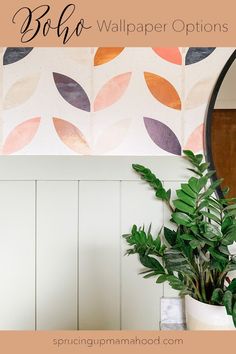 a potted plant sitting on top of a table next to a mirror and wallpaper