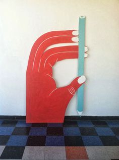 a red hand holding a blue toothbrush in front of a white wall with checkered flooring