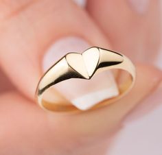 Our signet heart ring is 14k solid gold. Our gold heart ring has a unique style with looks like a folded heart. It fits your all outfit and becomes your everyday ring. When you think of our 14k gold heart ring as a gift, it is a product that will make your loved ones happy on their birthday, valentine's day, mother's day, anniversaries, graduations, or other special days. Also, it can be a perfect gift for yourself. :) 🎁 If you want, you can add a gift note for your loved ones. It arrives in a Folded Heart, Fw 2024, Gold Heart Ring, Heart Shaped Jewelry, Everyday Ring, Solid Gold Ring, Heart Shaped Rings, Emerald Pendant, Classy Jewelry