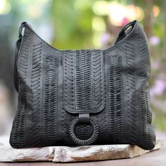 In the Balinese language, anyaman is the word for wicker. Drawing inspiration from wicker designs, Tuniyaton creates this hobo handbag, which is crafted by hand from black leather with intricate patterns that are woven and strung through the leather's surface. A flap conceals a zipper that opens to a faux suede-lined interior with a zipper pocket on one side and an open pocket on the other. Leather Braided Tote Bag, Black Woven Leather Rectangular Hobo Bag, Leather Travel Bag With Interwoven Design, Natural Leather Bag With Interwoven Design, Leather Bags With Open Weave For Daily Use, Leather Bags With Open Weave For Everyday Use, Everyday Leather Bag With Open Weave, Everyday Rectangular Braided Hobo Bag, Everyday Braided Rectangular Hobo Bag