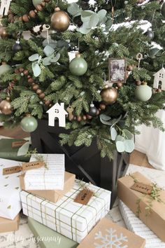 a christmas tree with presents under it