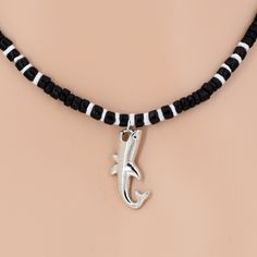 Black Coconut, White Puka Shell Beads Necklace with Vertical Silver Plated Alloy Shark Pendant Shark is 32 mm or 1-1/4 Inches Long by 13 mm or 1/2 Inch Wide Choose 19 Inches length or 22 and 25 Inches by attaching a screw on coconut bead extender. See pictures. In stock and shipped daily from Florida USA JEWELRY CARE: All jewelry will feel the effects of improper care. You should remove jewelry before any type of bathing or water activity. Store your jewelry in zip lock type bags or compartmenta Sea Shell Jewelry, Shark Pendant, Surfer Jewelry, Boys Necklace, Water Activity, Shell Beads Necklace, Puka Shell Necklace, Shark Necklace, Princess Necklace