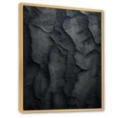 an abstract black and white painting with wood frame hanging on the wall in a room