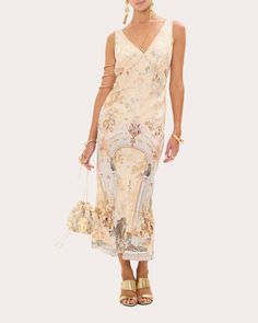 Rooted in minimal tailoring, this sleeveless dress accentuates its V-neck bodice with overlapped back panels and a bias-cut empire waistline. The silk jacquard canvas displays Camilla's Adorned in Antiquity print for vintage appeal. Zip closure Bias-cut empire waistline Overlapped back bodice Jacquard 65% viscose, 35% silk Dry clean Made in China Size & Fit Size XXS (US 2): 30.7in bust, 24in waist, 35.2in hips Size XS (US 4): 32.7in bust, 26in waist, 37.2in hips Size S (US 6): 34.6in bust, 28in Chic Luxury V-neck Dress With Floral Print, Gold Embroidered V-neck Dress, Chic V-neck Jacquard Dress, Vintage Embroidered V-neck Dress, Chic Luxury Floral Print V-neck Dress, Canvas Display, Empire Waistline, Dresses Xs, Mother Of The Bride