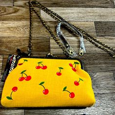 Adorable Mustard In Color Embroidered Cherry Handbag! This Handbag Comes With Interchangeable Straps. One Is A Long Chain Like Crossbody And The Other Is A Small Vegan Leather Strap. It’s About 9 Inches Long At The Widest Part, 6.25 Inches Tall And About 1.5 Inches Wide. It Has A Small Interior Open Pocket. Retro Yellow Shoulder Bag For Daily Use, Yellow Pouch Shoulder Bag With Mobile Phone Pocket, Yellow Shoulder Bag With Mobile Phone Pocket For Summer, Yellow Shoulder Bag With Mobile Phone Bag For Summer, Yellow Retro Shoulder Bag For Everyday Use, Yellow Retro Shoulder Bag For Summer, Retro Yellow Shoulder Bag For Everyday, Retro Yellow Shoulder Bag For Summer, Retro Yellow Shoulder Bag