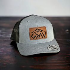 This is a custom made leather patch Hat!   These are made to order. Hat brand is Yupoong 6606 ! Trucker  style Hat with a SnapBack design.  Custom God is Greater Than the Highs and Lows Patch design !  Please choose your color of hat you would like and color of patch.  Leather Patches are bonded to all hats **not stitched on** We use a powerful leather bonding and heat pressed for maximum bonding to the hat .  We Do Custom Orders !  If you want a specific brand of hat or color feel free to messa Christian Hats For Men, Outdoor Hat With Curved Brim And Leather Backing, Trucker Hat With Leather Patch And Short Brim, Custom Flat Brim Snapback Hat For Outdoor, Outdoor Leather-backed Cap, Outdoor Short Brim Hats With Logo Patch, Custom Outdoor Hat With Flat Bill, Leather Patch Cap For Outdoor Activities, Adjustable Hats With Leather Backing For Outdoor