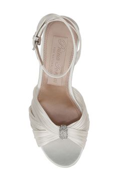 Bridal designer Pnina Tornai adds signature crystal and heart embellishments to this forever-elegant sandal set atop a slim heel. 3 1/4" heel Adjustable ankle strap with buckle closure; hidden elastic inset Textile upper and lining/leather sole Imported Glamorous Wedding Shoes With Removable Insole, Elegant Wedding Sandals, Feminine Wedding Sandals With 4-inch Heel, Elegant Wedding Sandals With Removable Insole, Chic Embellished Sandals For Wedding, Elegant Sandals With Heel Strap For Prom, Elegant Wedding Sandals With Heel Strap, Elegant Crystal Embellished Ankle Strap Sandals, Crystal Embellished Ankle Strap Wedding Shoes