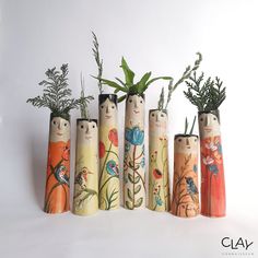 five wooden vases with plants in them