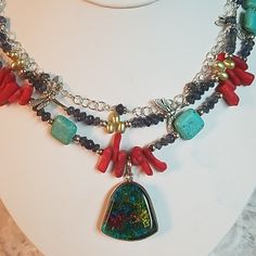 This Is A One-Of-A-Kind Handmade Necklace By Jewelry Artist Deborah Kwitney From Art Is Me. This Necklace Featured Sterling Silver Chain, Clasp, And Other Elements. It Features Red Coral, Turquoise, Iolite, And Freshwater Pearls. As A Reference To Nature, There Are Silver Dragonflies Throughout The Necklace. This Necklace Would Be An Awesome Statement Piece And Would Dress Up Any Outfit You Would Want To Pair It With! The Necklace Measures 18 In Long And The Dichoric Glass Pendant Measures 1 In. Handmade Multi-strand Glass Jewelry, Unique Glass Jewelry With Lobster Clasp, Artisan Red Glass Jewelry, Unique Turquoise Glass Necklaces, Jewelry Artist, Coral Turquoise, Artistic Jewelry, Handmade Necklace, Red Coral