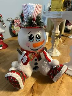 a snowman sitting on top of a wooden table