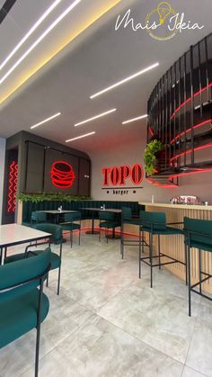 an empty restaurant with green chairs and neon lights