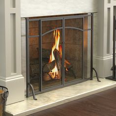 a fireplace with a fire in it sitting on top of a hard wood floor