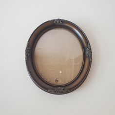 a round mirror hanging on the wall