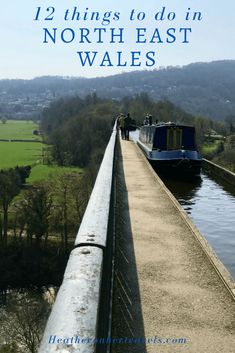 a boat traveling down a river next to a bridge with the words, 12 things to do in north east wales