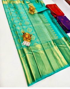 The saree is made of pure silk kanjeevaram/kanchipattu with 2 gram gold zari, Pallu, and blouse.  this grand saree is ideal for wedding parties ocations and festivals  Upon request: Tussels, fall and pico and blouse work (will be done with extra charges  Excellent quality with beautiful colours and combinations. Gold Silk Mark Certified Saree For Puja, Gold Silk Mark Certified Saree For Festivals, Gold Traditional Wear Silk Mark Certified For Festivals, Gold Traditional Wear For Festivals With Silk Mark, Festive Gold Traditional Wear With Silk Certification, Green Temple Jewelry Style Saree For Puja, Grand Saree, Kanchipattu Sarees, Sarees Silk