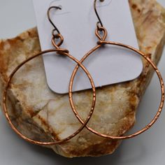 These medium-sized antique copper-toned hoop earrings feature a minimalist design. The warm copper lends a vintage charm, while the simple hoops maintain a versatile and understated sophistication. Perfect for any occasion, they seamlessly blend classic and modern aesthetics. Style Details: Coated copper ear wires Coated copper hoops All earrings come with rubber backs. Drop from the ear pierce is approximately 2.75" and the hoop diameter is about 1.75" While I do not offer refunds/returns/excha Ear Pierce, Cary Nc, Modern Aesthetics, Cotton Pads, Jewelry Earrings Hoops, Minimalist Earrings, Antique Copper, Vintage Charms, Ear Wires