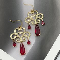 ❤️Deliver gifts on time with our recommended ship-by dates.❤️ - 16 DEC USPS first class mail - 18 DEC USPS Priority mail - 20 DEC USPS Priority mail express High quality, sparkly, gold framed red teardrops glass stones hang from gold plated ornate filigree pendant. They are perfect for evening and also look great as a statement accessory on a casual outfit! They would make a fabulous gift for Christmas, birthday or Valentines Day! Measurements: The total length from the top of the hook to bottom - 1.88 inches (48 mm) approximately. Ornate filigree:  27 mm x 22 mm Crystals: 10 mm x 7 mm and 6 mm x 4 mm These earrings would be a PERFECT GIFT for you and your family and friends! Come beautifully packaged in a gift box!  Click here to see more Modern Everyday Earrings: https://etsy.me/2UJldl1 Elegant Valentine's Day Earrings For Festive Occasions, Elegant Valentine's Day Festive Earrings, Red Teardrop Chandelier Earrings As Gift, Teardrop Earrings For Valentine's Day Party, Glamorous Dangle Teardrop Earrings, Glamorous Dangle Teardrop Earrings Gift, Glamorous Teardrop Dangle Earrings, Glamorous Dangle Teardrop Earrings For Gifts, Elegant Red Drop Crystal Earrings