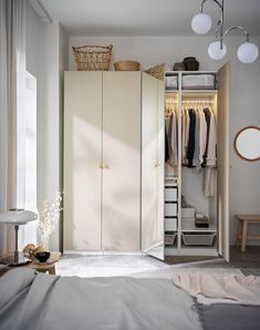 an open closet with clothes hanging in it