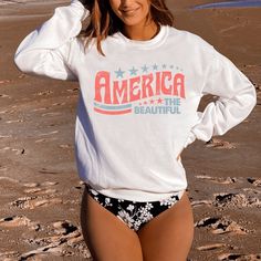 Celebrate the 4th of July in our retroAmerica The Beautiful sweatshirt. Perfect for the beach, summer BBQs and campfires on summer evenings.  A sturdy and warm sweatshirt bound to keep you warm in the colder months. A pre-shrunk, classic fit sweater that's made with air-jet spun yarn for a soft feel and reduced pilling. * 50% cotton, 50% polyester * Pre-shrunk * Classic fit * 1x1 athletic rib knit collar with spandex * Air-jet spun yarn with a soft feel and reduced pilling * Double-needle stitch Casual American Flag Print Top For Vacation, American Flag Print Cotton Top For Beach, White American Flag Print Top For The Beach, White American Flag Print Top For Beach, White American Flag Print Tops For Beach, White Tops With American Flag Print For Beach, Cotton Summer Tops For 4th Of July, Patriotic Tops For 4th Of July Vacation, Patriotic Cotton Tops For Vacation