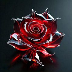 a red glass rose sitting on top of a table