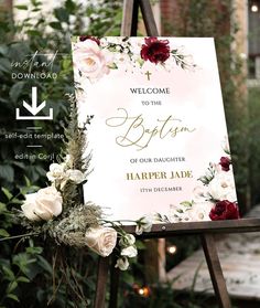 a wedding ceremony sign with flowers and greenery