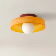 an orange and white light hanging from the ceiling