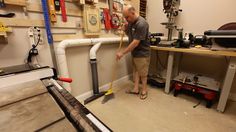 a man standing in a room with tools on the wall