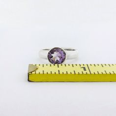 "A sterling silver ring with a gorgeous bright purple faceted amethyst. Available in US ring sizes 6-8. The natural amethyst gemstone is 8mm (3/8\" inch). Please message me if you would like a size not listed. Custom orders are welcome!" Amethyst Ring With Round Stone, Amethyst Ring With Center Round Stone, Amethyst Ring With Round Center Stone, Purple Solitaire Amethyst Ring, Amethyst Ring With Bezel Setting, Purple Amethyst Ring With Bezel Setting, Faceted Amethyst Ring For Anniversary, Silver Faceted Amethyst Ring, Faceted Amethyst Ring Gift