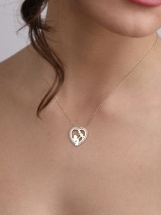 "The 14K Gold Heart Mom Hug Baby Necklace with CZ Heart Mom Hug Baby Pendant is a stunning representation of the eternal love between a mother and her child. This necklace isn't just jewelry; it's a heartfelt symbol of the bond shared between a mom and her little one. It's the perfect gift for new moms, whether for a baby shower, Mother's Day, or just to celebrate the joy of motherhood. With its elegant design and meaningful symbolism, this necklace is sure to be treasured for years to come. Pro Fine Jewelry Heart Necklace With Birthstone For Wedding, Wedding Heart Necklace With Birthstone In Fine Jewelry Style, Wedding Heart Necklace With Birthstone, Wedding Fine Jewelry Heart Necklace With Birthstone, Personalized Heart Necklace In Cubic Zirconia For Wedding, Personalized Cubic Zirconia Heart Necklace For Wedding, Diamond Heart Necklace For Wedding And Mother's Day, New Mom Jewelry, Baby Necklace