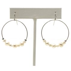 If you are looking for a pair of pearl earrings that showcase this seasons most popular silhouette, these freshwater pearl hoop earrings are a perfect pick. With a trendy style that is here to stay, these June birthstone earrings will stand out. These pearl dangle earrings are this seasons must have fashionable accent. Length: 2 inches Width: 1 3/8 inches Drop: 1 1/2 inches Closure: Hook Weight: 0.2 oz Hypo Allergenic Nickel free and lead free Shipped within 1 business day Our dangle earrings fo Adjustable White Pearl Hoop Earrings, Adjustable Hoop Pearl Drop Earrings, Freshwater Pearl Earrings Silver, Bridesmaid Pearl Earrings, Delicate Wedding, Costume Fashion, Freshwater Pearl Earrings, Pearl Dangle Earrings, Birthstone Earrings