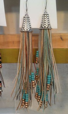 two pairs of earrings hanging from hooks