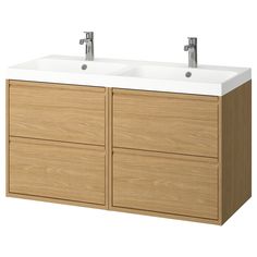 two white sinks sitting on top of a wooden cabinet