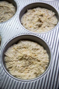 four muffin tins filled with batter sitting on top of a table