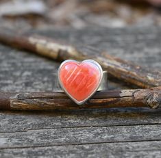 15mm orange / pink spiny oyster heart is set in pure silver on an 8mm wide sterling silver band. This item is made to order.  Variations in stones will occur.  Please leave a note in the message to seller at checkout if you would like to choose your heart ❤️ Orange Stone, Silver Heart Ring, Spiny Oyster, Sterling Silver Heart, Sterling Silver Bands, Pure Silver, Ring Gift, Stone Rings, Jewelry Sales