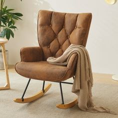 a brown rocking chair sitting on top of a white rug