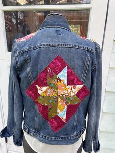 a denim jacket with patchwork on the back