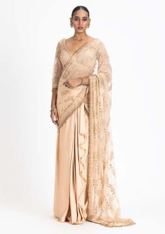 Step into the spotlight with our nude satin draped sari. This ensemble features a net-embroidered palla and blouse intricately adorned with tonal dori, highlighted with beads and crystals, adding a... Elegant Pre-draped Saree With Sheer Dupatta For Reception, Elegant Festive Pre-draped Saree With Intricate Embroidery, Glamorous Pre-draped Saree With Resham Embroidery For Reception, Elegant Festive Pre-draped Saree With Dupatta, Eid Evening Pre-draped Saree With Resham Embroidery, Cream Pre-draped Saree For Reception, Festive Beige Pre-draped Saree For Wedding, Elegant Dola Silk Pre-draped Saree With Resham Embroidery, Silk Pre-draped Saree With Pearl Embroidery For Reception