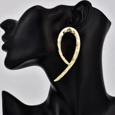 Elevate your style with our Nkono Statement Stud earrings. These lightweight earrings feature a stunning gold-plated design, adding a touch of sophistication to any outfit. At 2.95 inches, they make a bold statement without weighing you down. Perfect for everyday wear or special occasions. Chic Gold Teardrop Earrings For Party, Gold Chic Wrap Earrings, Chic Gold Wrap Earrings, Trendy Gold Teardrop Metal Earrings, Gold Metal Wrap Earrings For Party, Chic Gold Teardrop Earrings For Pierced Ears, Chic Gold Teardrop Earrings, Party Gold-tone Drop Hoop Earrings, Gold Chic Wrap Earrings For Party