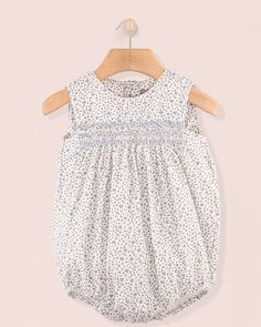 Kensington French Blue Floral Romper Casual Spring Bubble Romper With Smocked Back, Casual Bubble Romper With Smocked Back For Spring, Spring Floral Print Cotton Bubble Romper, Spring Sleeveless Bubble Romper With Smocked Back, Sleeveless Bubble Romper With Smocked Back For Spring, Summer Cotton Bubble Romper For Daywear, Cute Bubble Romper With Smocked Back For Summer, Cute Summer Bubble Romper With Smocked Back, Summer Cotton Smocked Bubble Romper