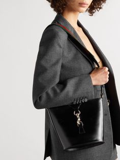 When you invest in one of Gucci's bags, you take home a small piece of the house's century-spanning legacy. This shoulder bag has been crafted by artisans in Italy from glossy textured-leather and secures with lobster clasp in the shape of the emblematic horsebit hardware. There's enough space inside for a your phone, hand lotion and a small wallet. Designer Gucci Bucket Bag With Detachable Strap, Gucci Formal Satchel Bag, Gucci Bucket Bag With Gold-tone Hardware For Travel, Gucci Bucket Bag With Gold-tone Hardware, Gucci Chic Bucket Bag With Gold-tone Hardware, Chic Gucci Bucket Bag With Gold-tone Hardware, Classic Gucci Bucket Bag, Gucci Bags With Metal Hardware For Work, Gucci Shoulder Bag With Brass Hardware For Evening