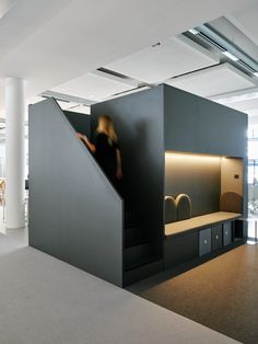 a person climbing up the stairs in an office