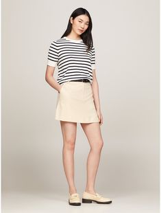 Tommy Hilfiger women's skirt. This mini skirt combines a playful silhouette with sophisticated details, such as understated logo embroidery above the back pocket.  Material: 66% Recycled Polyester (rpe), 32% Viscose (scv), 2% Elastane. Classic Summer Skort, Chic Mini Hem Skort For Work, Chic Mini Hem Shorts, Classic Summer Mini Skirt For Workwear, Summer Workwear Mini Hem Skort, Classic Summer Mini Skirt For Work, Summer Workwear Mini Skort, Classic Mini Skirt For Summer, Lined Skirt For Business Casual In Summer