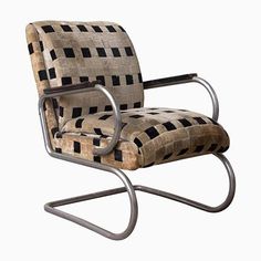 a chair that is sitting up against a white background with black and brown squares on it