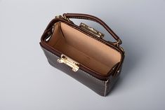 "*DOCTOR BAG'S HANDMADE VIDEO* https://youtu.be/QpdhSCjh2BM Product Description * Material: vegetable tanned leather * Color: Hand-dyeing chocolate * Flap over entry with buckle closure ,a rounded projection on the, please press it up to open the flap * 0.75\" wide leather shoulder strap : 110cm * Sewn by hand; * Size: 140mm (H) x 170mm (W) x 70mm (D) / 5.5\" x 6.7\" x 2.7\" Please first look at the production process of our product. 1. The vegetable tanned leather is made in Italy: Vegetable ta Everyday Brown Rectangular Box Bag, Luxury Brown Rectangular Bucket Bag, Brown Box Bag With Detachable Handle For Daily Use, Brown Leather-handled Crossbody Box Bag, Office Pouch Shoulder Bag With Leather Handles, Brown Satchel Box Bag For Daily Use, Brown Leather Box Bag With Removable Pouch, Rectangular Leather Bucket Bag With Top Handle, Brown Leather Box Bag With Top Handle