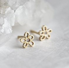 Cute flower stud earrings with tiny diamonds. Perfect gift! Studs are available in sterling silver, 14k/18k rose/white/yellow gold - please select the metal from the drop-down menu. If you would prefer a single earring, please contact us before purchase. If you would like to have other gemstones instead of diamonds please contact us before purchase regarding pricing. Item details: 14k/18k/rose white yellow gold, silver 1.1mm diamond x 2 5.5mm width The earrings will be shipped in a gift box with 14k Gold Flower Charm Earrings, Dainty Yellow Gold Pierced Flower Earrings, Dainty Yellow Gold Flower Earrings, Dainty 14k Gold Flower Earrings, Dainty 14k Yellow Gold Flower Earrings, 14k Gold Diamond Flower Earrings For Gift, 14k Gold Diamond Flower-shaped Earrings As Gift, 14k Gold Diamond Flower Earrings As Gift, 14k Gold Flower-shaped Diamond Earrings As Gift