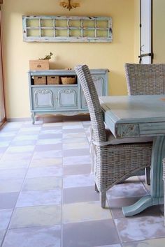 a table and chairs in a room with yellow walls