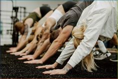 a group of people doing push ups in a row