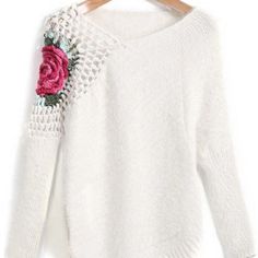 a white sweater with a pink rose on it